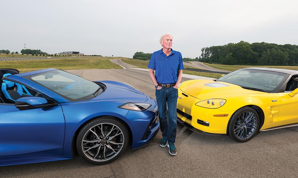 photo of Corvette engineer Tadge Juechter with blue Corvette and a yellow Corvette